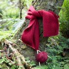 thumbnail of knitted scarf around a tree photo